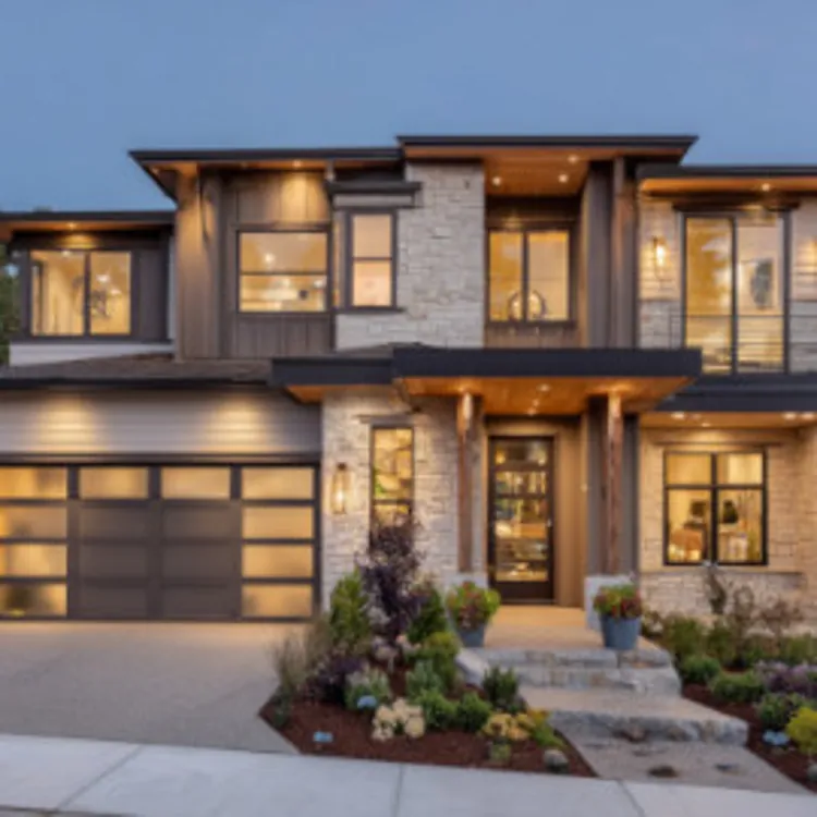 a two-storey house with the lights on early at night