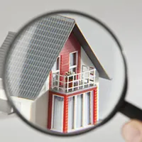 a model house viewed through a magnifying glass