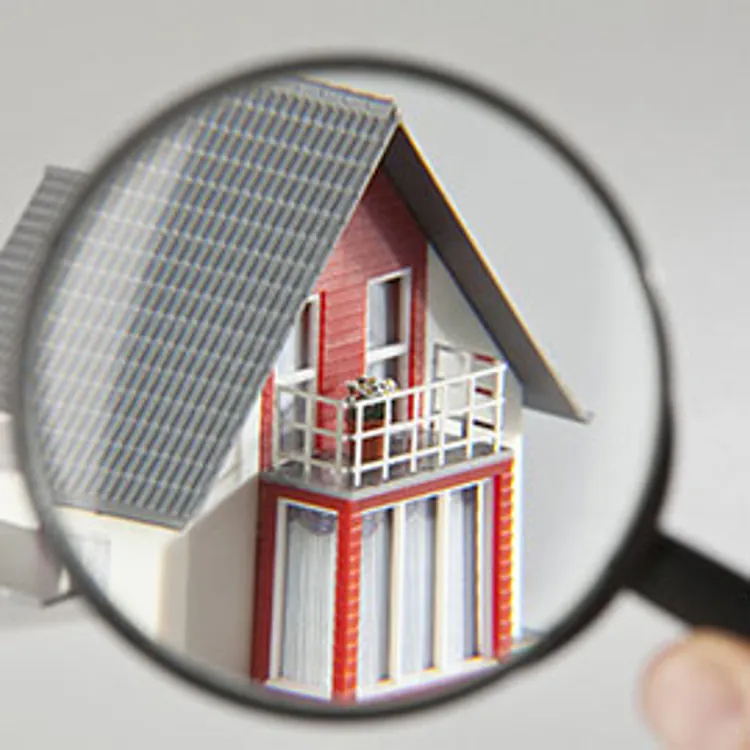 a model house viewed through a magnifying glass