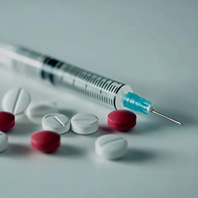 pills and injection syringe