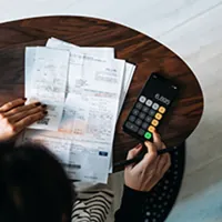 Girl using calculator for mortgage rates