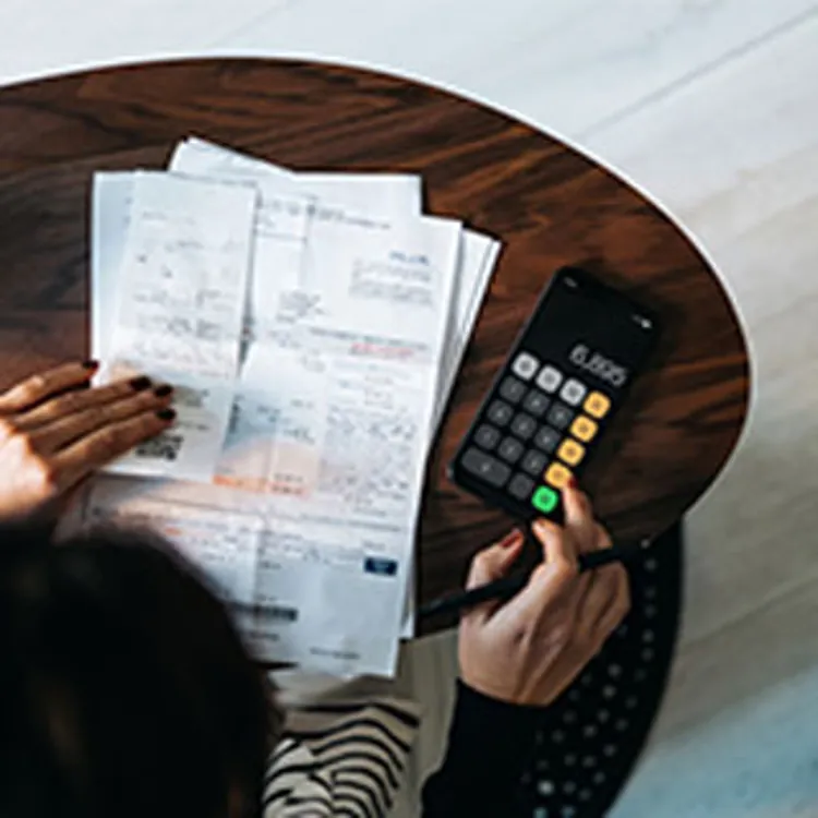 Girl using calculator for mortgage rates