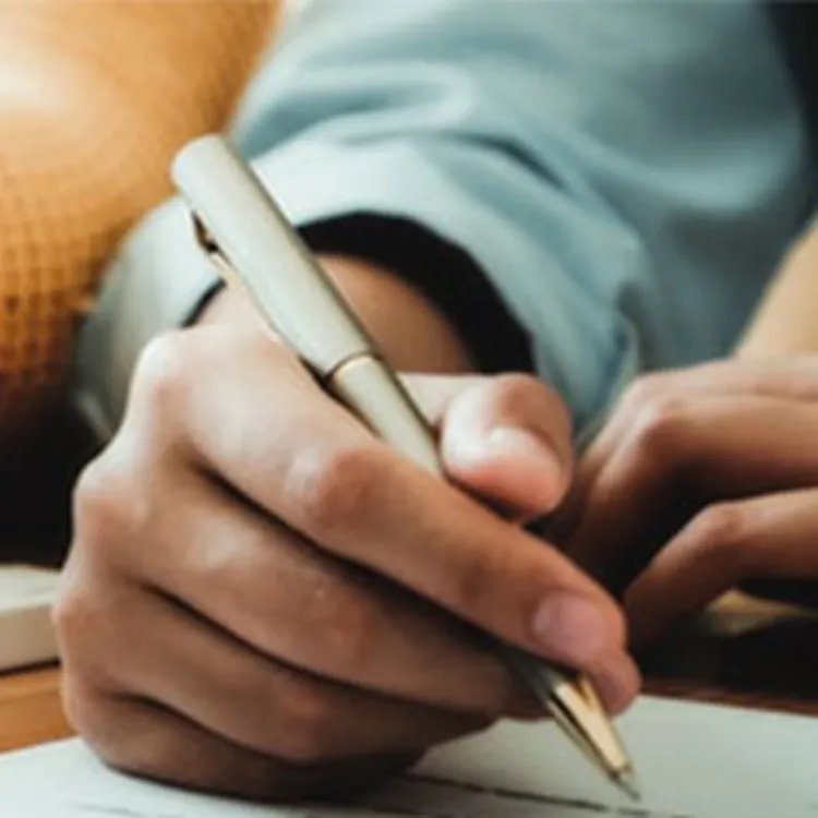 Man writing on paperwork