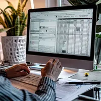 image showing a man working on a desktop computer