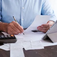 man calculating personal expenses