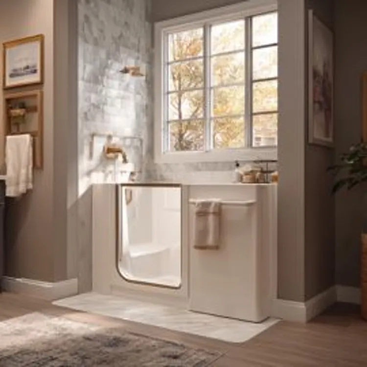 a white walk-in bathtub set in a neutral colored bathroom softly lit by naturally sunlight from a large window