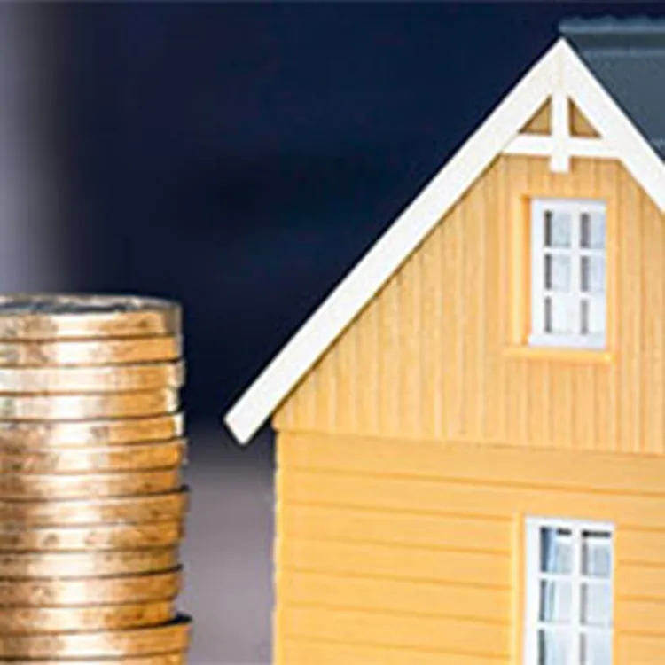 coin stack in front of small house