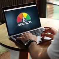 man looking at credit score on laptop screen