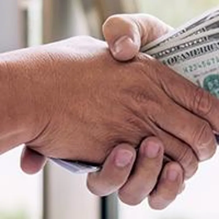 Shaking hands with money