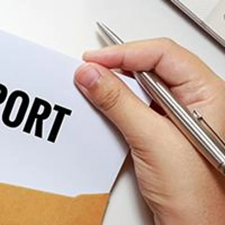 one hand holding a silver metallic pen while pulling a credit report out of a brown envelope