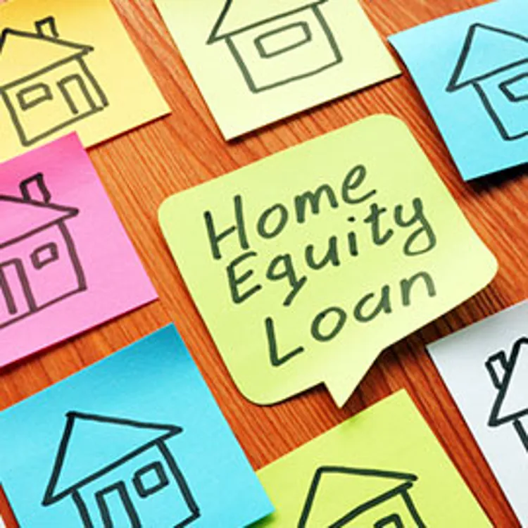 home equity loan phrase written on a green memo paper surrounded by house drawings on memo papers in various colors