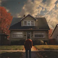 man looking at a house