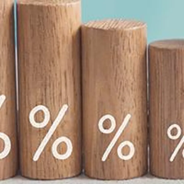 stack of wooden cylinders decreasing in height with percentage signs painted on them