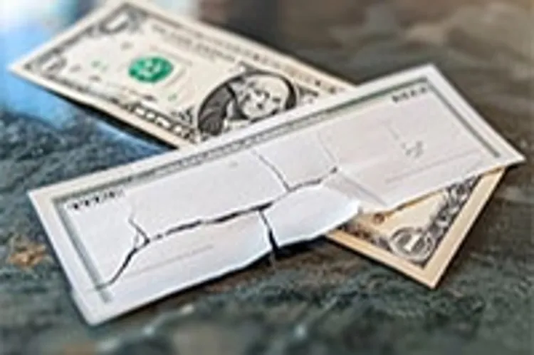 dollar bill with a torn envelope on top