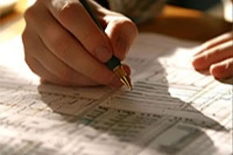 man filling in tax form