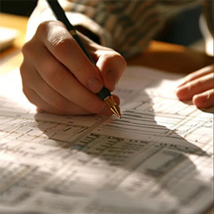 man filling in tax form