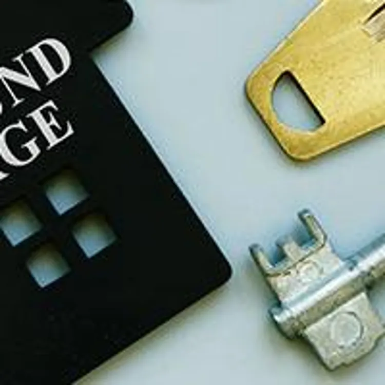 small house with wraparound mortgage engraved and keys in the background