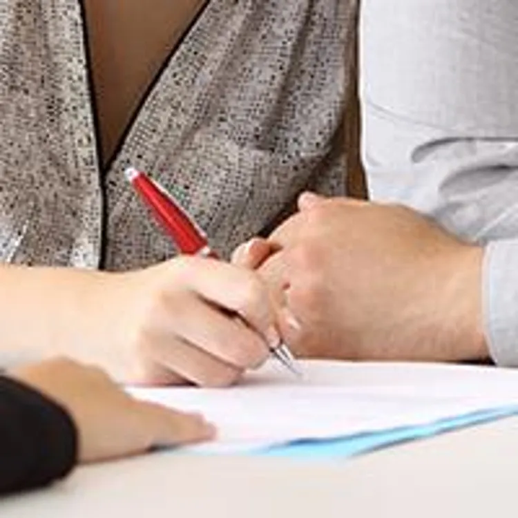 couple signing papers at the banks