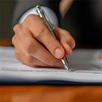 image showing hand holding a pen and writing