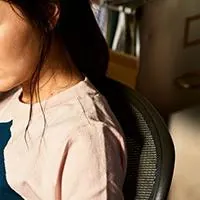 woman talking on phone while looking at document