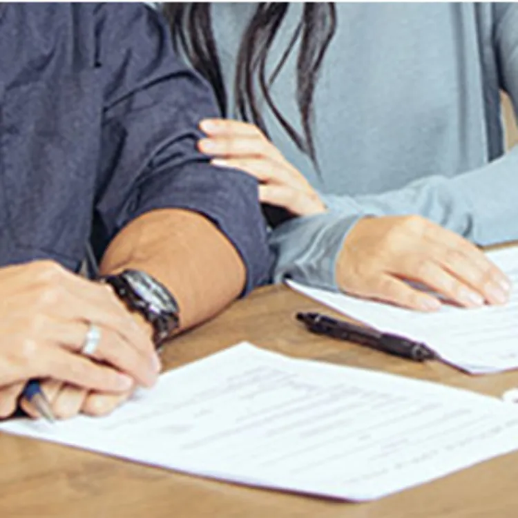 couple with paperwork on table applying for loan
