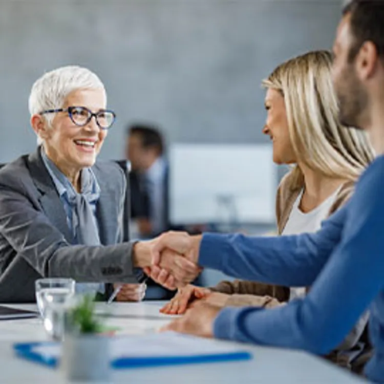 couple meeting with mortgage lender rep