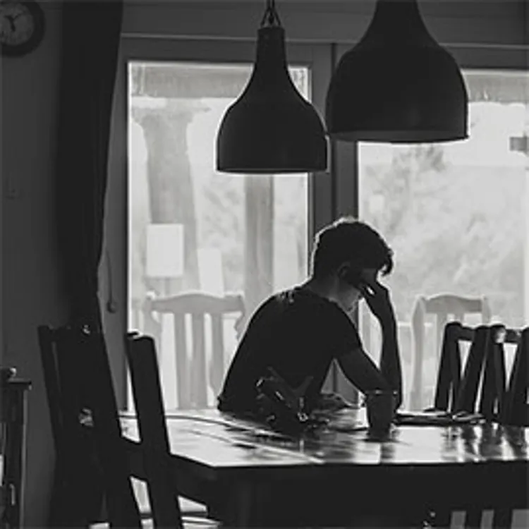 man on the phone at a table in their home