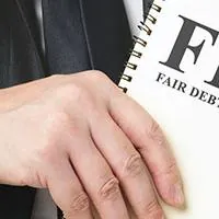 man holding a copy of the fdcpa