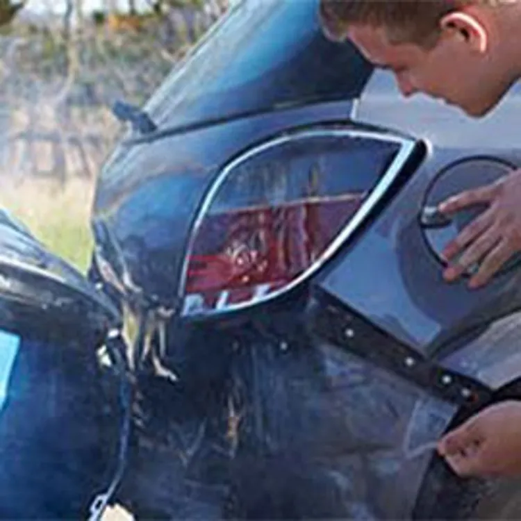 man examining fender bender