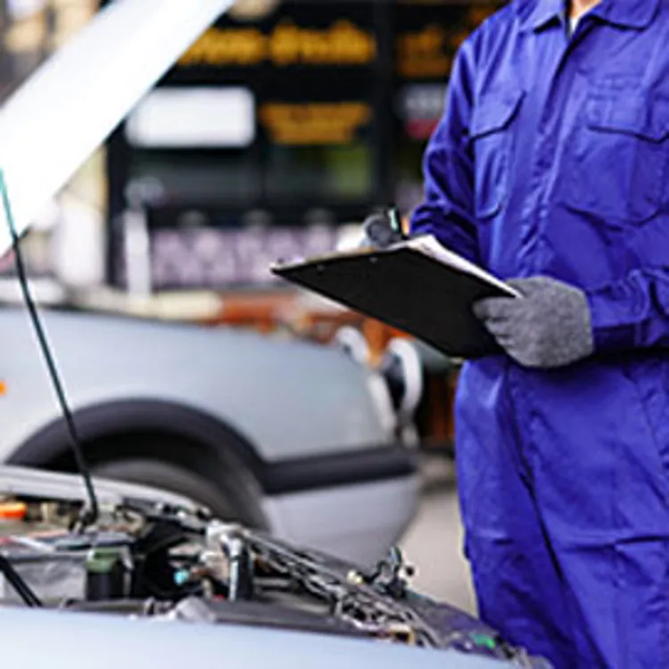 Guy inspecting car