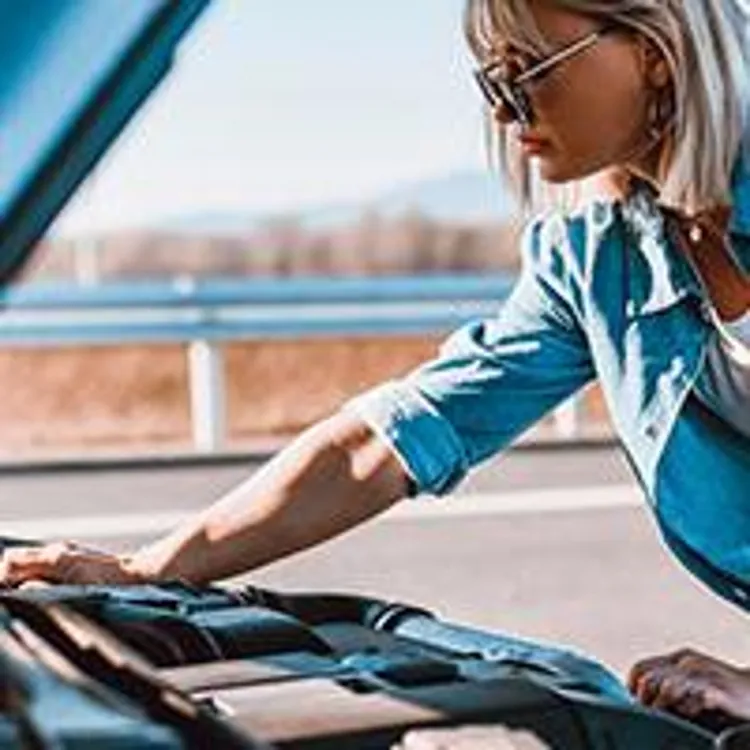 woman checking car engine