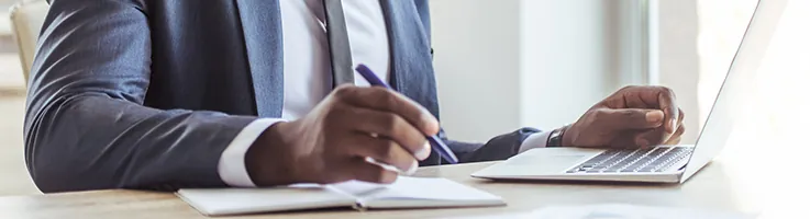 lawyer sitting at a desk working on a laptop