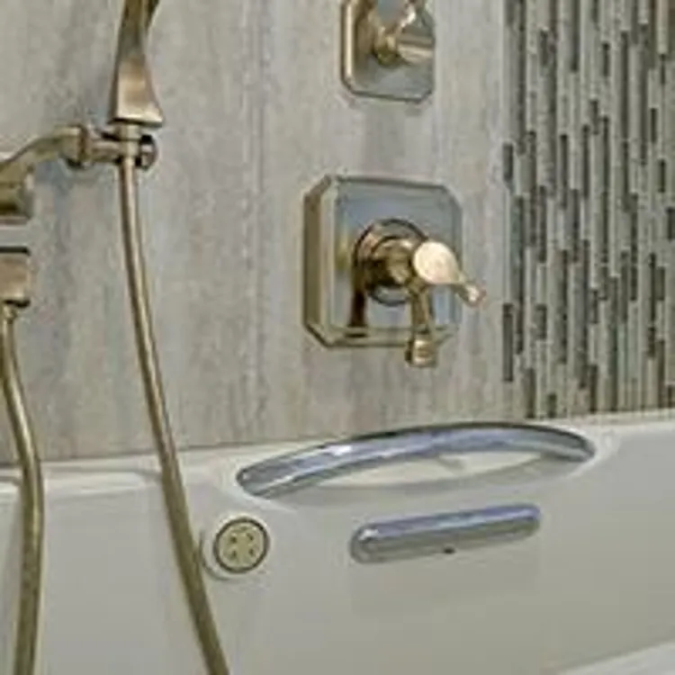 white walk in bathtub with gold accessories