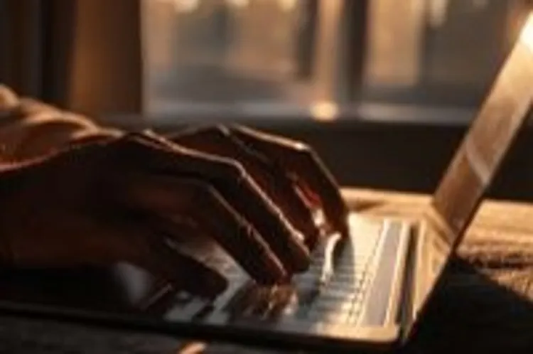 a man using his laptop to type