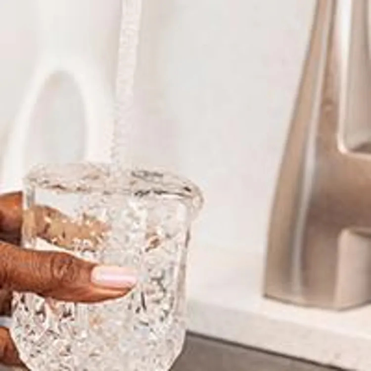 woman filling glass with water
