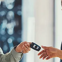 woman getting keys to new car