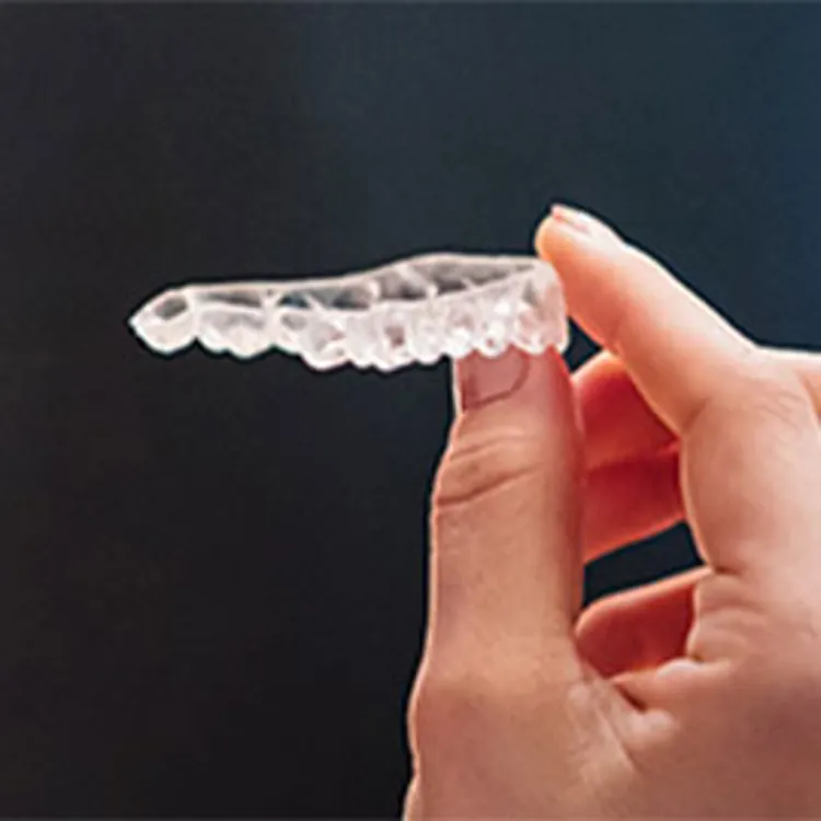 woman holding invisible braces
