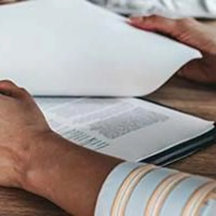 woman signing loan paperwork