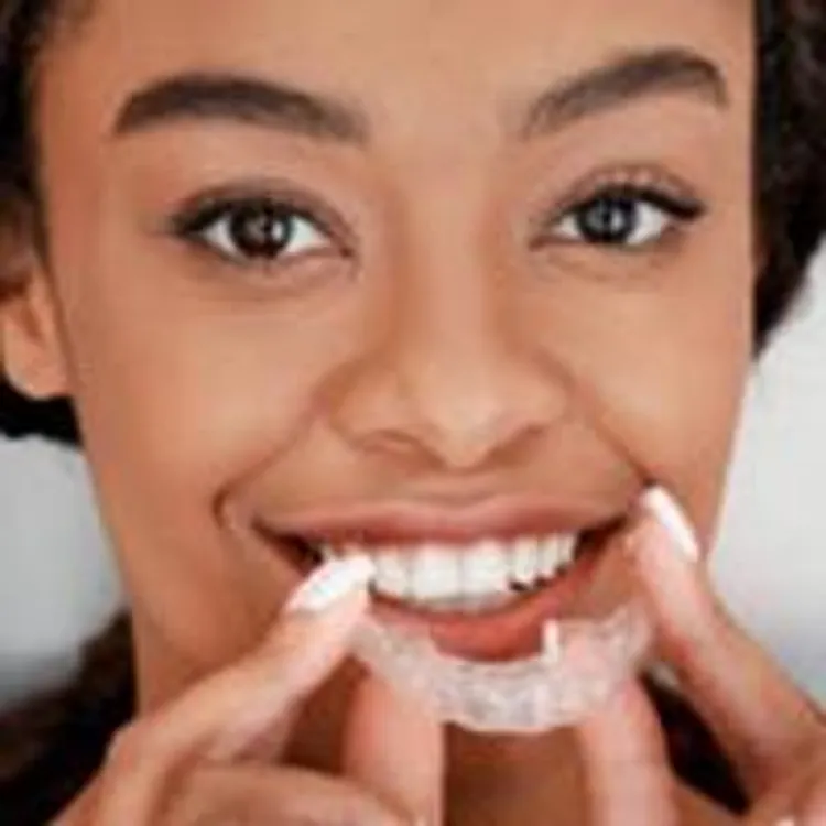 woman with clear teeth aligners