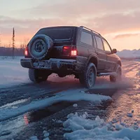 an suv driving on an icy road